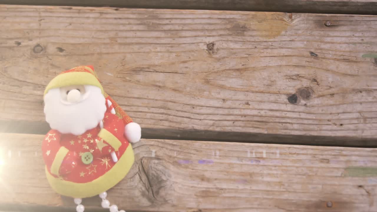 Animation of santa claus christmas decoration on wooden surface