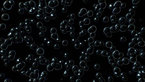 des bulles se multiplient et éclatent sur un fond noir