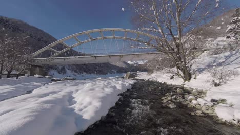 Flying under a snowy bridge in Georgia