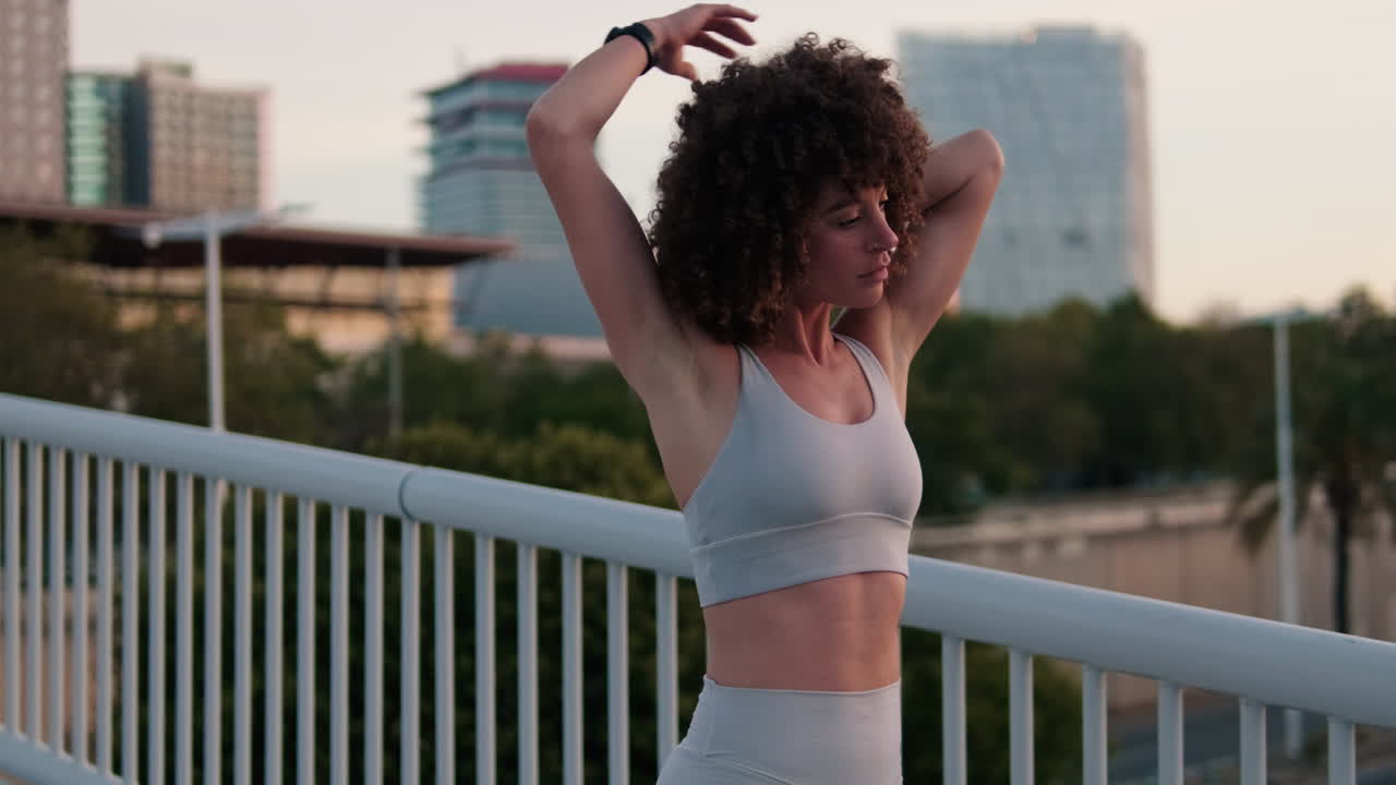 Woman Stretching on City Bridge