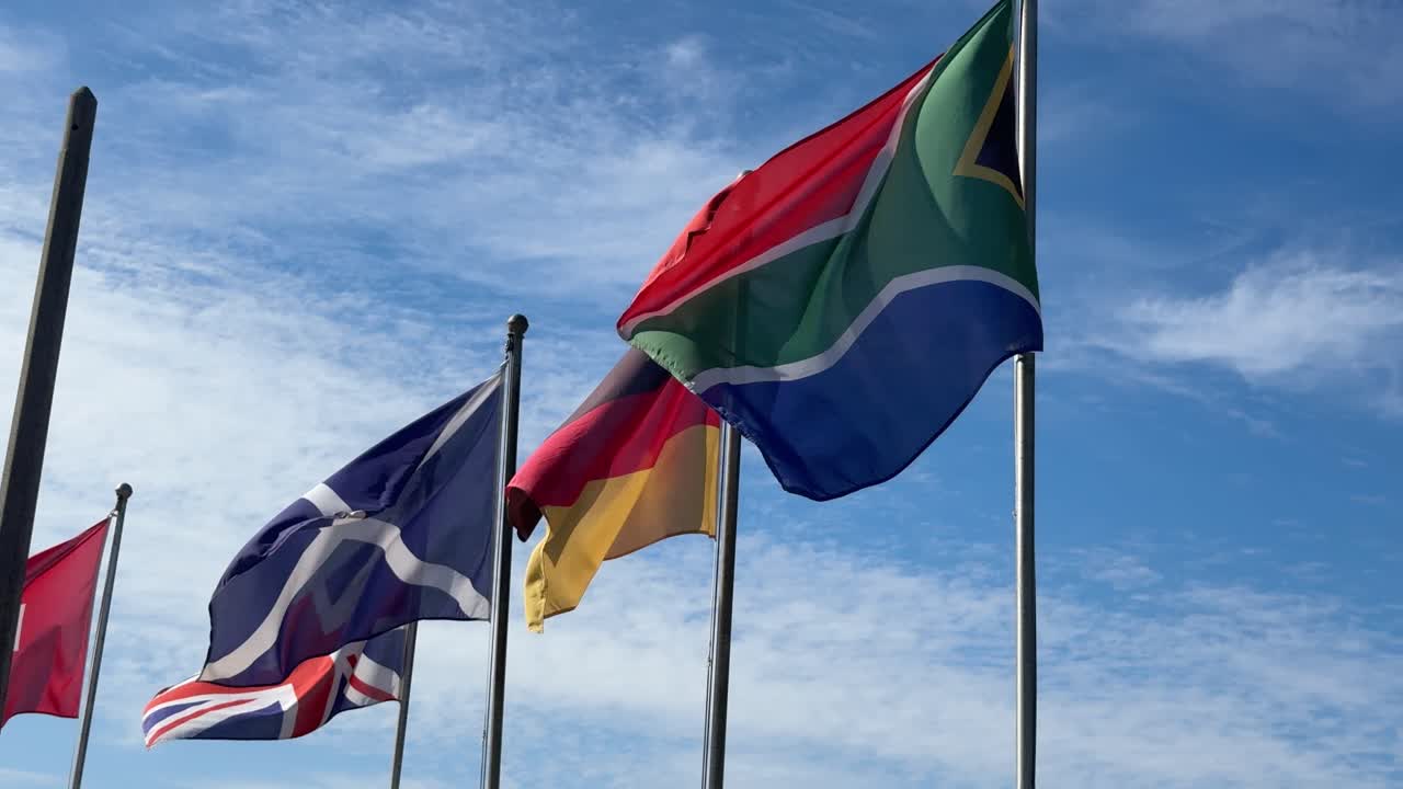 Various flags of different countries around the world at a golf course in Cape Town, South Africa.