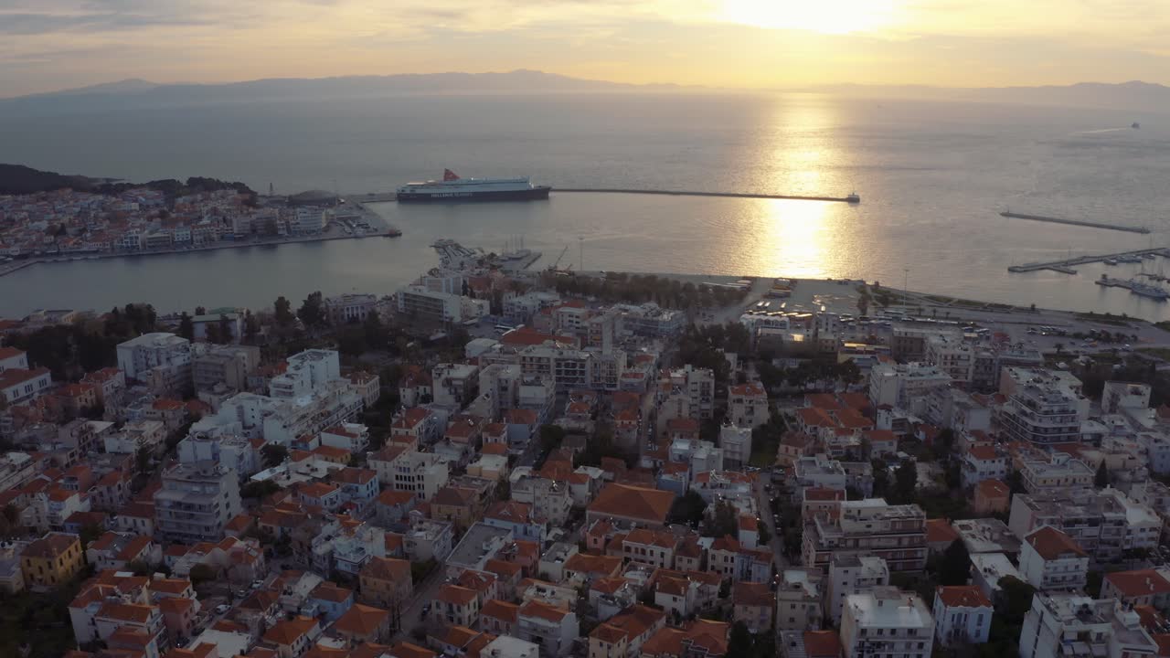 Historical Buildings And Houses With Glorious Sunset And Reflections On The Calm Ocean  In Mytilene City In Lesvos Island, Greece. - aerial drone shot