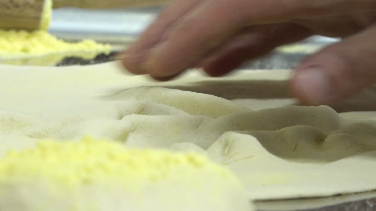 Man kneading pizza dough by hand