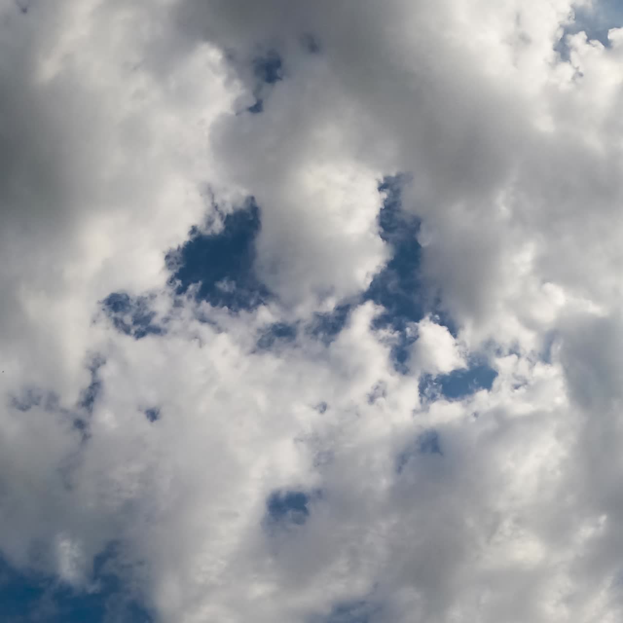 Bright sun shining in the sky and lighting the clouds. Low angle view timelapse