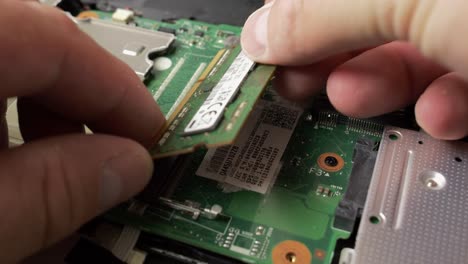 "Repair-of-an-old-laptop,-the-technician-is-dismantling-the-parts