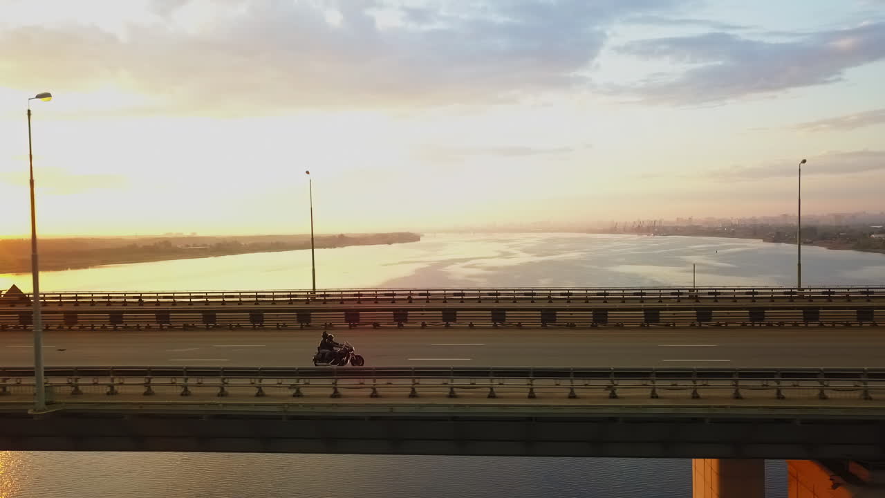 Motorcycle Ride on Bridge at Sunset