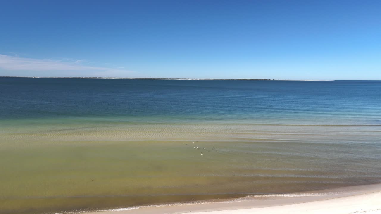 Asphalt walkway leading through sandy dunes towards the beautiful blue bay, Panama City Beach, Florida, USA