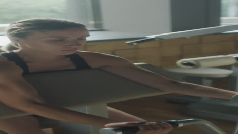 woman using preacher curl machine in gym