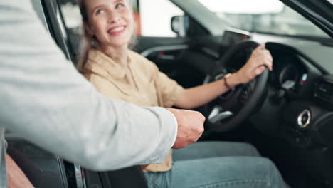woman sitting in a car holding the keys