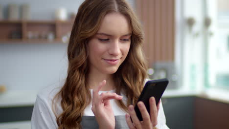 caucasian woman using phone in the kitchen