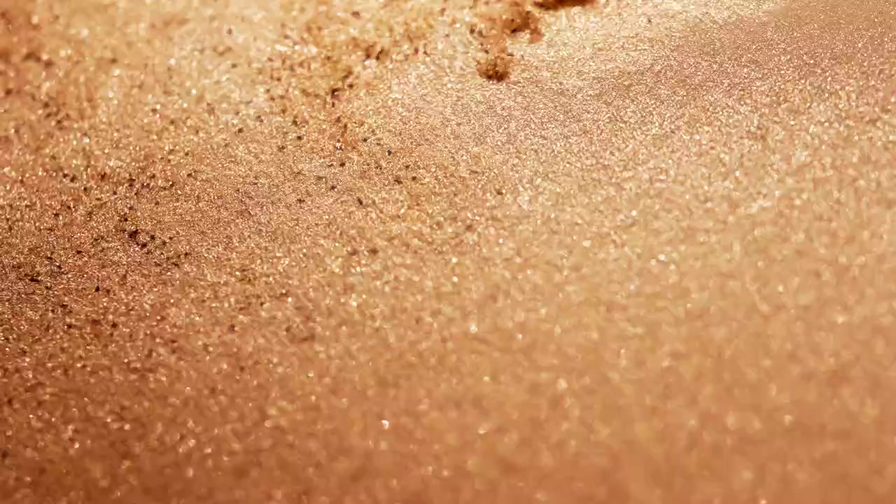 Scatto macro astratto di particelle di sabbia che si spostano al rallentatore