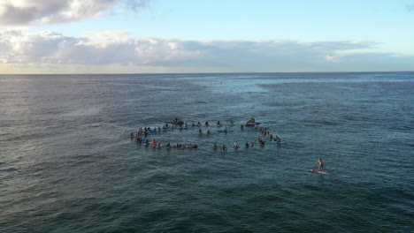 a group of people hold a paddle out memorial ceremony on the water in bondi australia