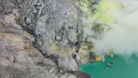 dramatic aerial view of a crater acid lake kawah ijen where sulfur is mined