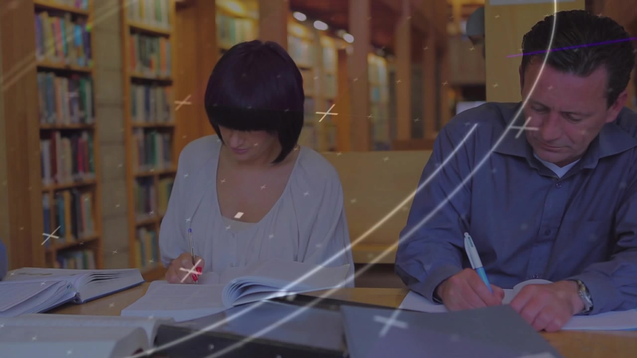 With swirling graphics appearing, woman flipping pages and man marking notes in library education