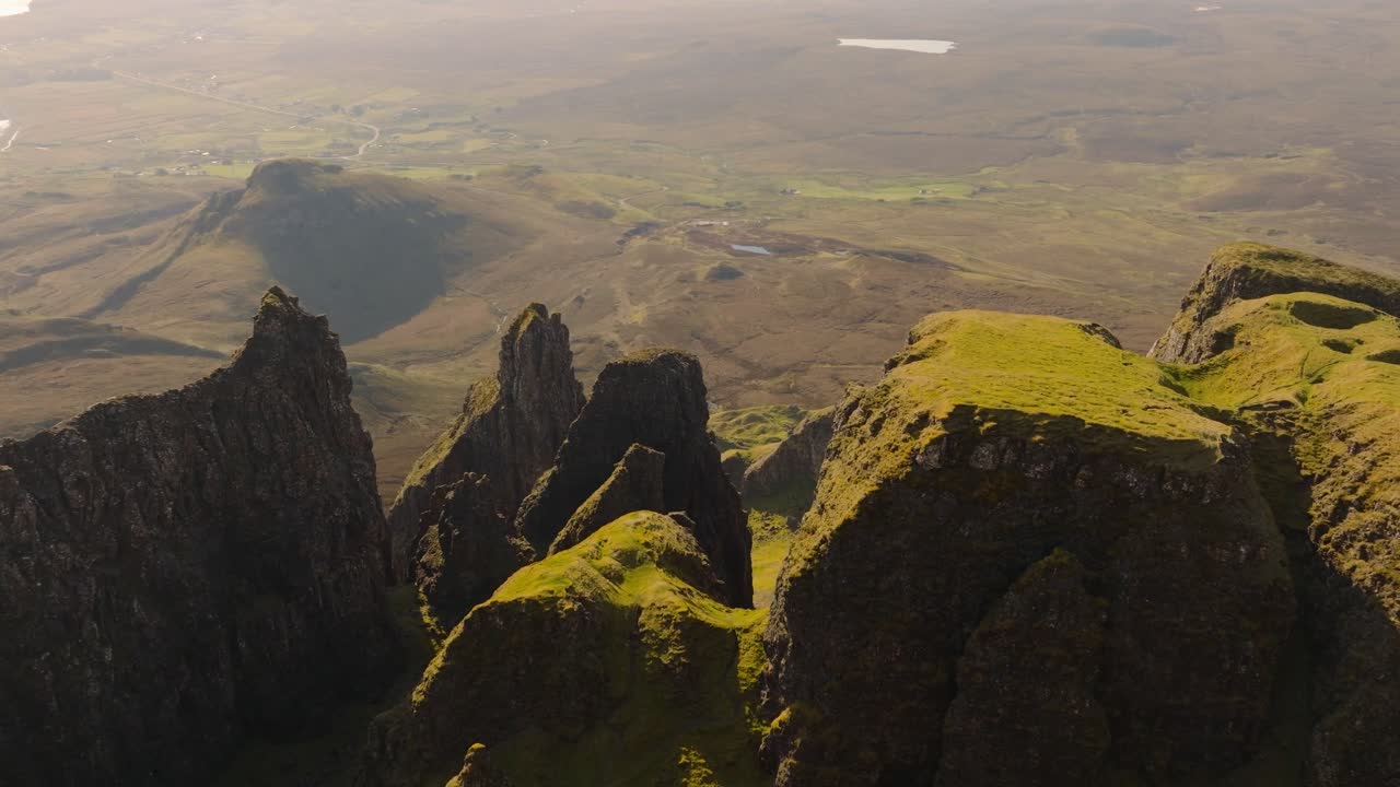 Aerial drone footage of the dramatic mountain landscapes on the Isle of Skye, Scotland. Sweeping panoramic views of majestic peaks, green valleys, and wild nature. Quiraing walk