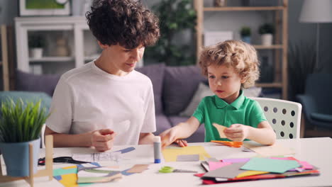 mother and child creating a paper collage