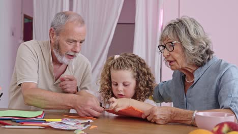 Grandparents doing crafts with a child