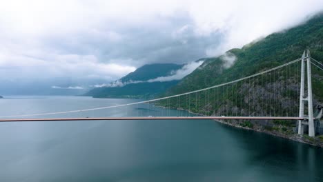 hardanger bridge in norway, pan left to right, cloudy rainy weather