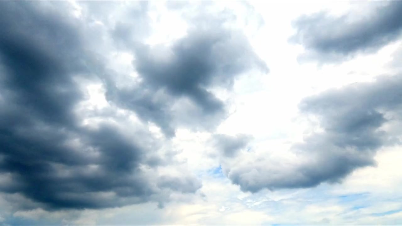 Timelapse of dramatic cloud formations moving across an open sky, creating dynamic natural patterns and changing atmospheric conditions.