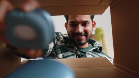 Feliz-Hombre-Indio-Comprador-Desempacando-Caja-De-Cartón-Paquete-De-Entrega-Compras-En-Línea-Compra-En-Casa