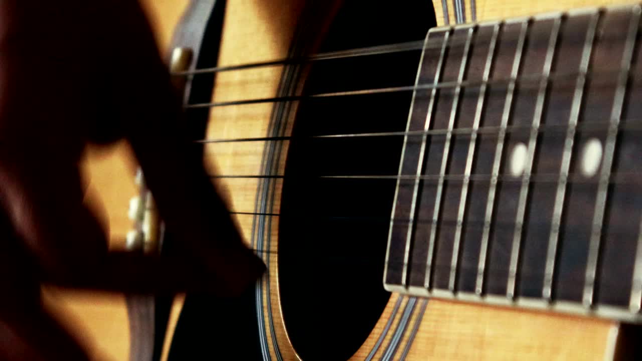 Close up of woman hand playing guitar