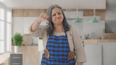 happy indian aged housewife showing thumbs down