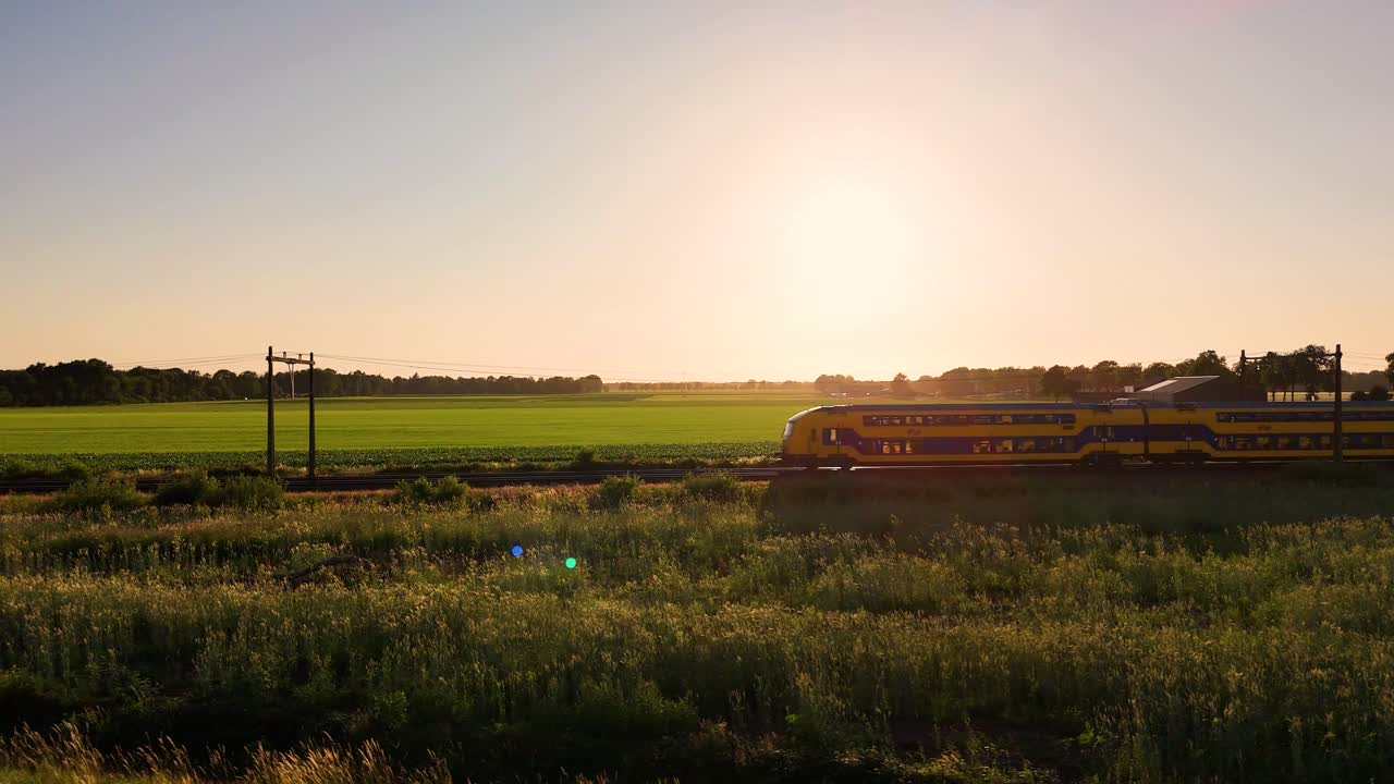 Train Passing Through Scenic Rural Landscape at Sunset