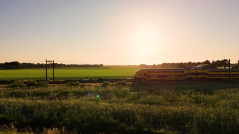 train passing through scenic rural landscape at sunset