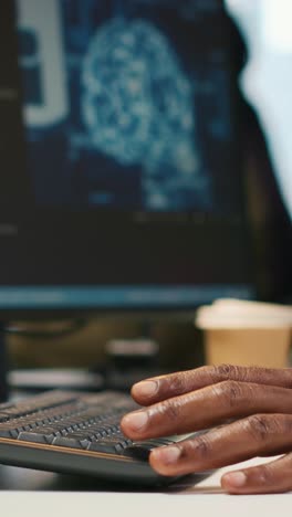 vertical video technician using mockup laptop next to office coworkers developing applications