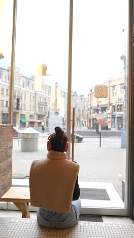 woman enjoying coffee and city view in a cafe