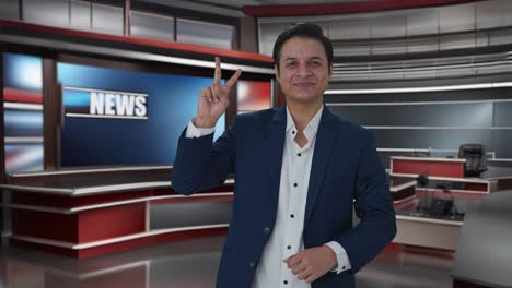 happy indian journalist showing victory sign