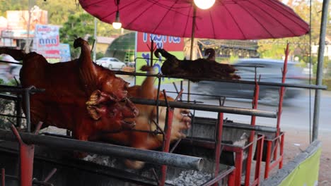 rotisserie pig cooking over open flame