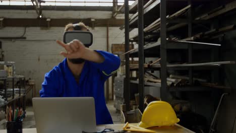 Metalsmith-using-laptop-and-virtual-reality-headset-4k