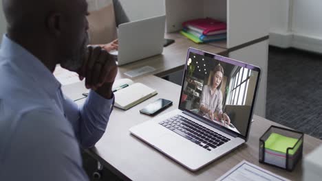 African-american-senior-man-having-a-video-call-with-female-colleague-on-laptop-at-office