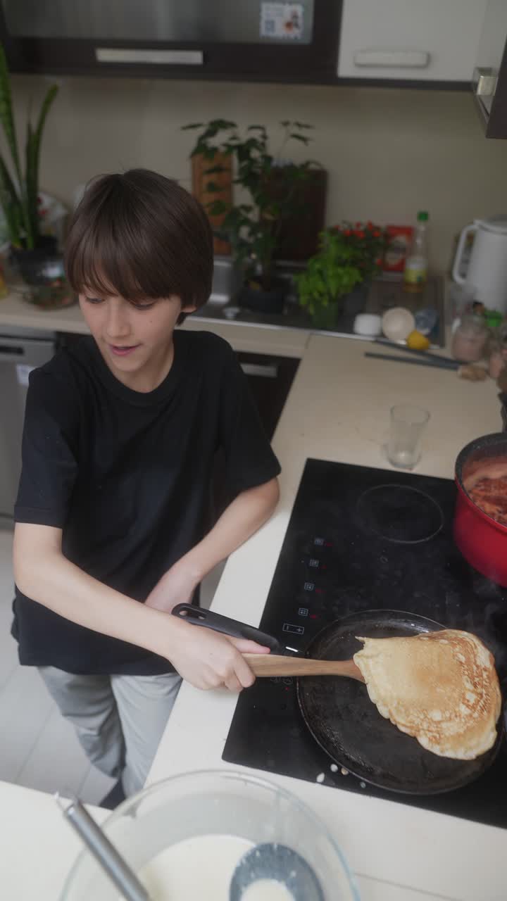 Boy Cooking Pancakes in a Kitchen