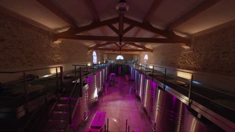 Descend-into-a-Spectacular-Wine-Cellar-with-Oak-Barrels,-Stone-Walls,-and-Colorful-Lighting