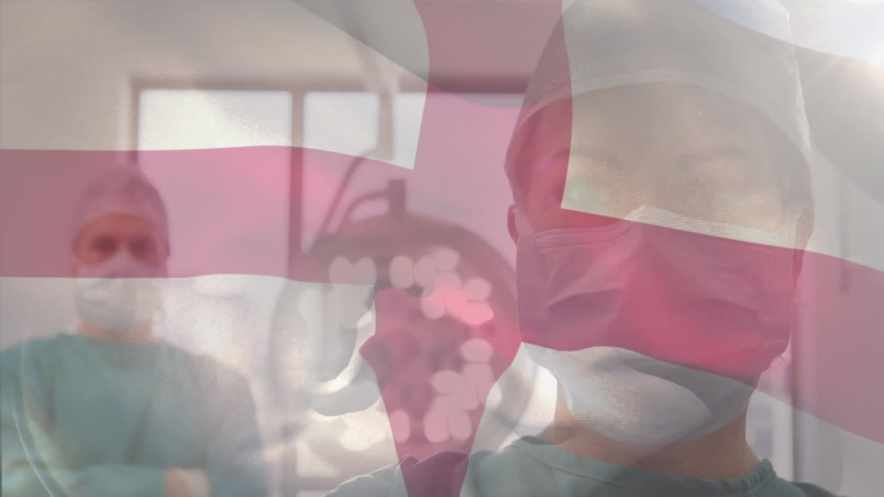 수술실에서 외과 의사 들 위 에 흔들리는 영국 국기 의 애니메이션