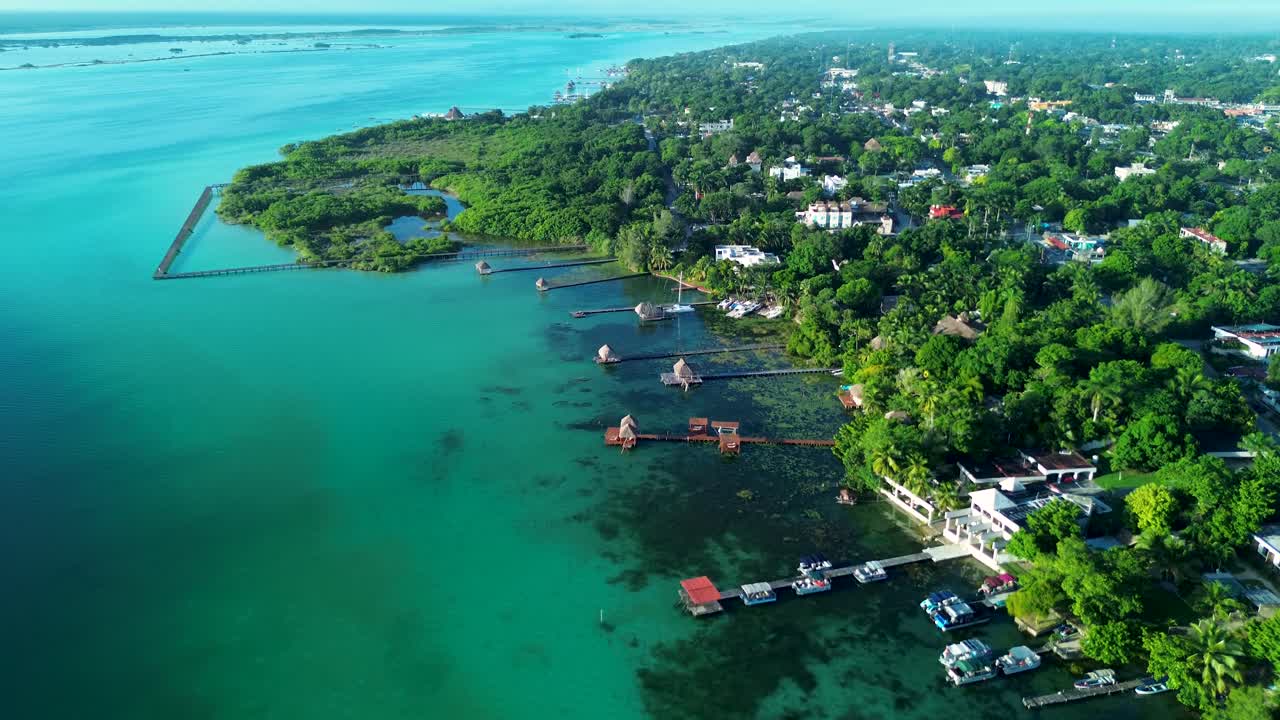 Aerial View of a Tropical Coastal Town with Turquoise Lagoon