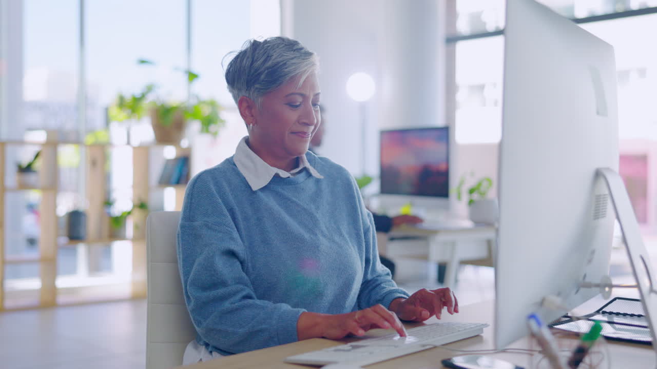 Business, thinking and mature woman on a computer