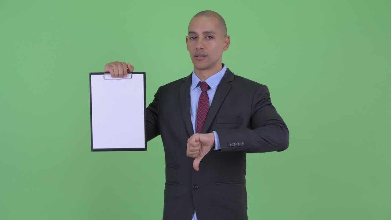 Stressed bald multi ethnic businessman with clipboard