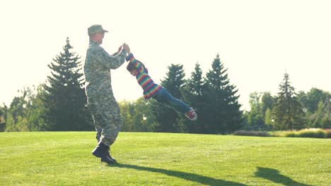 father and daughter playing circling around at the park.