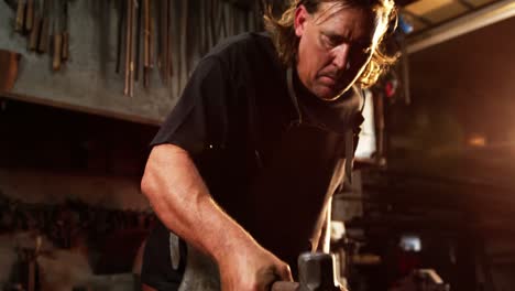 blacksmith working on a iron rod