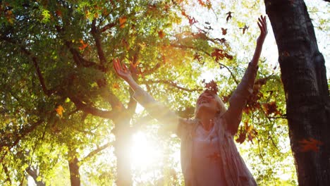 happy woman throwing maple