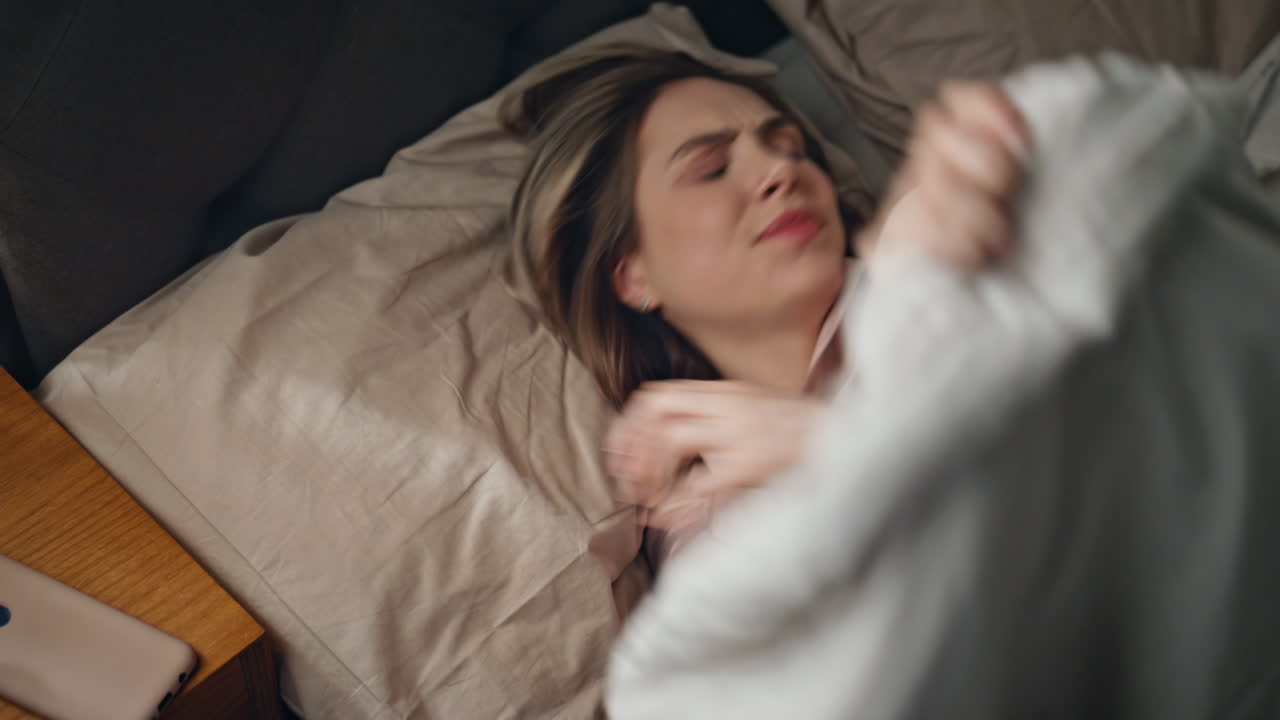 Woman in bed using phone