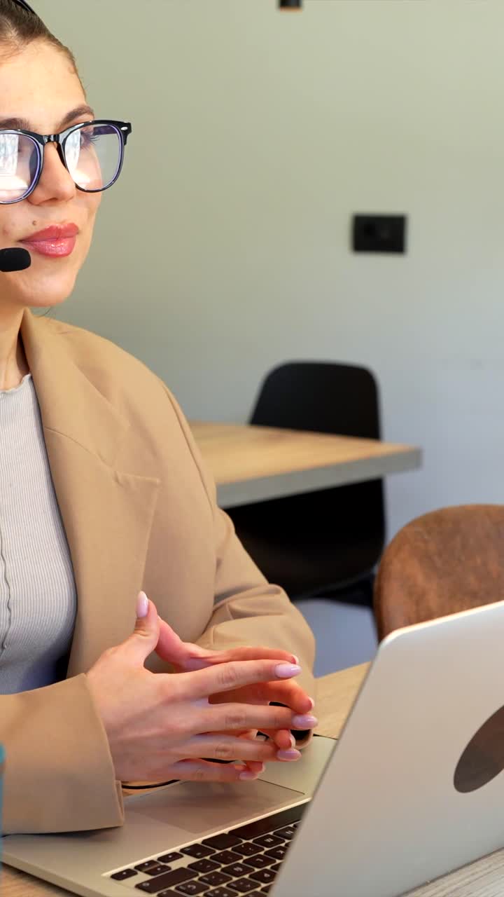 Businesswoman working at her laptop during a video call