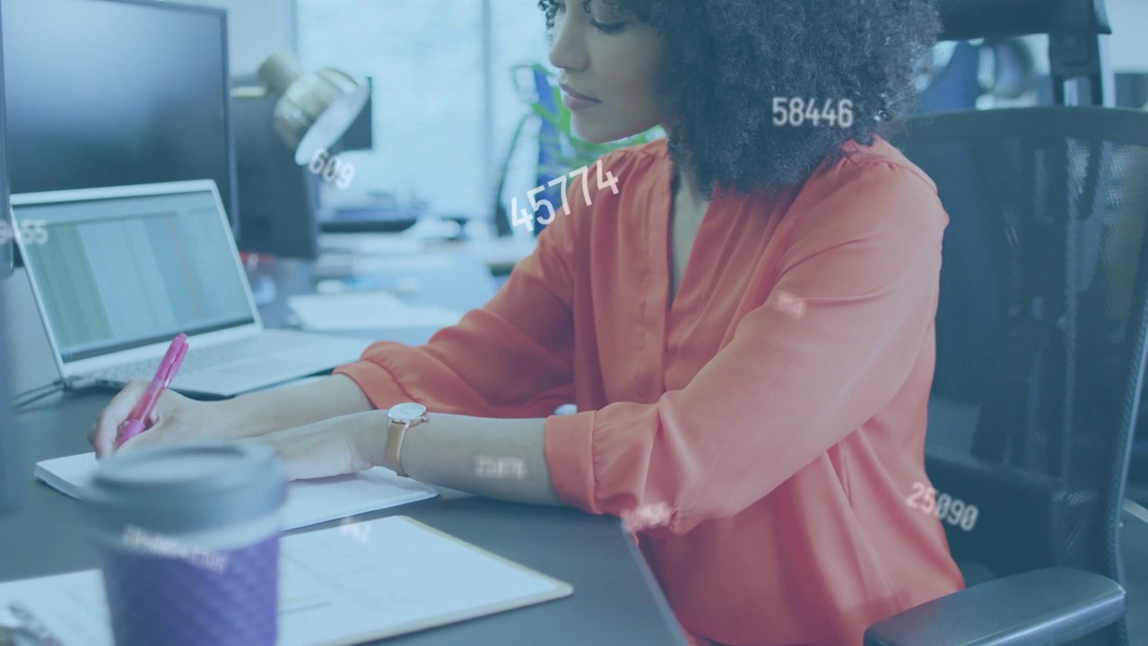Woman checking sheet and picking pink pen, updating analysis while data overlay floating over desk