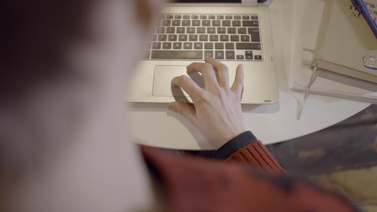 Person working on a laptop in a coffee shop