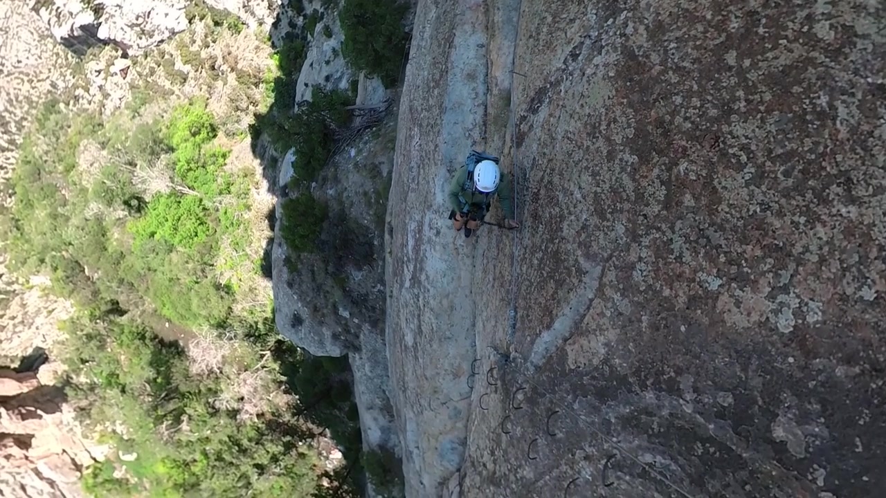 Hombre caminando sobre una roca de acantilado, vista de cámara cenital de 360 grados