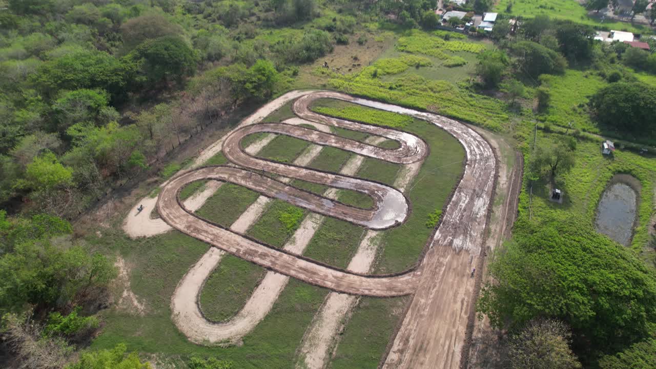Motocross track seen from above, dirt loops in lush green rural Venezuela