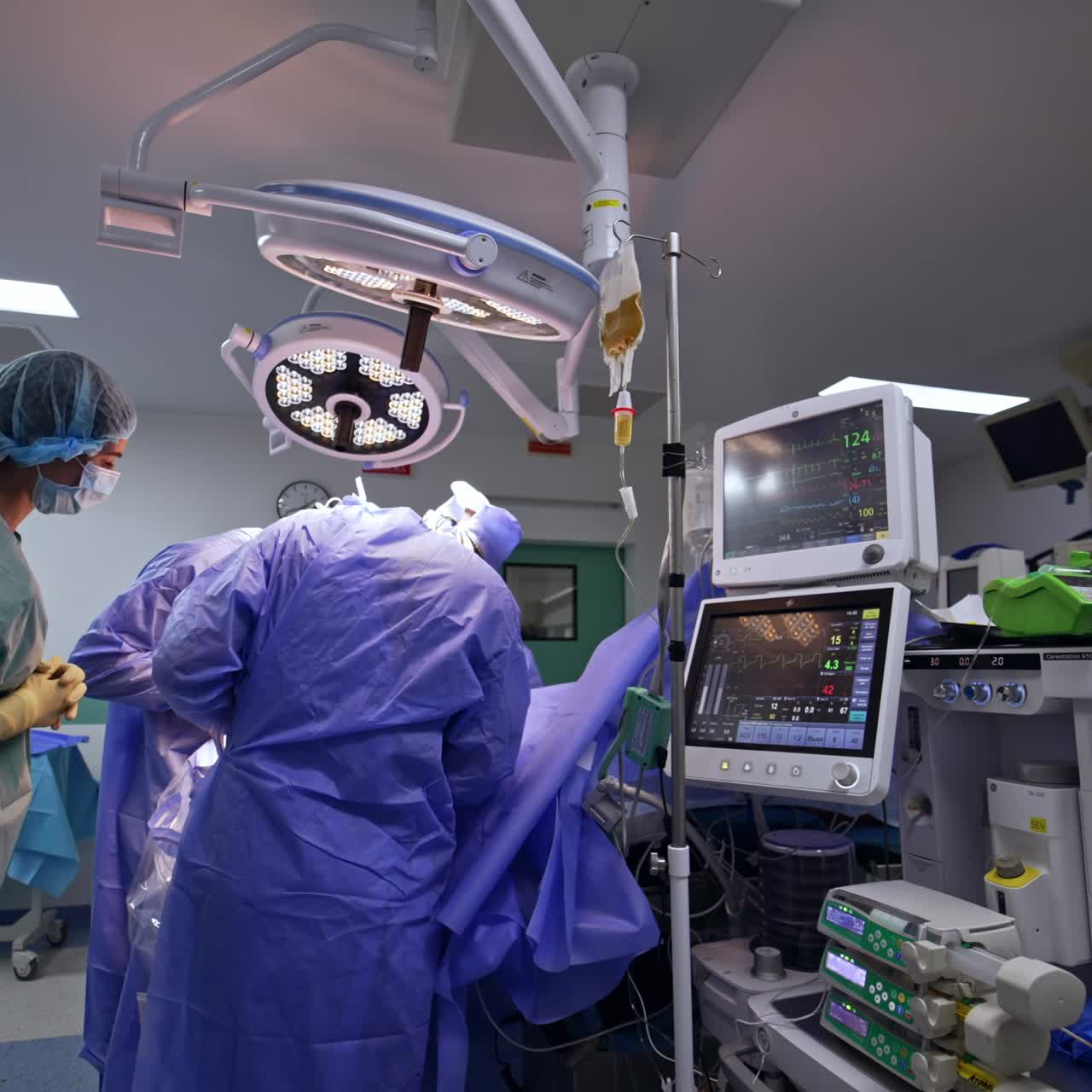Modern neurosurgical operation in well-equipped hospital operational room. Doctors and assisting staff surrounded the surgical table performing procedure